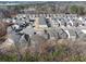 A wide aerial shot captures a modern residential neighborhood, showcasing its layout, green spaces, and community atmosphere at 4722 Blake Loop, Atlanta, GA 30349