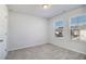 This bedroom has light gray walls, carpet flooring, and windows with blinds at 4722 Blake Loop, Atlanta, GA 30349