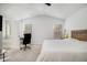 Bright bedroom with a vaulted ceiling, plush carpet, and a wood headboard at 4722 Blake Loop, Atlanta, GA 30349