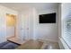 This bedroom has a modern TV and a closet near a cozy carpeted floor at 4722 Blake Loop, Atlanta, GA 30349