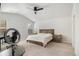Comfortable bedroom featuring a sloped ceiling, lots of light and a wooden bedframe at 4722 Blake Loop, Atlanta, GA 30349