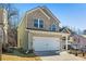 Two-story home with brick and siding, a two-car garage, and a well-kept lawn at 4722 Blake Loop, Atlanta, GA 30349