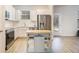 Modern kitchen with stainless steel appliances, white cabinets, and wood-look flooring at 4722 Blake Loop, Atlanta, GA 30349