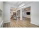 An open-concept layout with wood floors, a kitchen view and a modern light fixture adds charm to the living room at 4722 Blake Loop, Atlanta, GA 30349