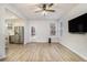 Bright living room with wood-look flooring and an open layout leading to the kitchen at 4722 Blake Loop, Atlanta, GA 30349