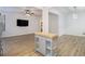 Bright living room with an open floor plan boasts wood floors and a kitchen island for additional workspace at 4722 Blake Loop, Atlanta, GA 30349