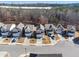 Charming, new construction homes line a quaint street, each with a driveway and attached garage, in a picturesque community at 4722 Blake Loop, Atlanta, GA 30349