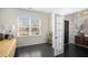 Open dining area with dark hardwood floors and a gold accent table at 500 Mariposa Ln, Mcdonough, GA 30253