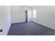 Cozy bedroom with gray carpeting, a window and a doorway to the hall at 109 Shirley Se Ln, Acworth, GA 30101