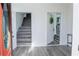 Bright foyer featuring modern flooring, a staircase, and doorway views of the kitchen at 109 Shirley Se Ln, Acworth, GA 30101