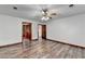 Large bedroom with wood floors, ceiling fan and access to bathroom and other rooms at 3898 Buckland Dr, Lilburn, GA 30047