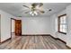 Spacious bedroom with wood flooring, ceiling fan, and access to other rooms at 3898 Buckland Dr, Lilburn, GA 30047