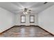 Well-lit bedroom, featuring wood floors and a ceiling fan at 3898 Buckland Dr, Lilburn, GA 30047