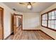 Bright bedroom featuring wood floors and access to hallway at 3898 Buckland Dr, Lilburn, GA 30047