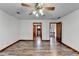 Spacious bedroom with wood flooring, ceiling fan and access to bathroom and stairs at 3898 Buckland Dr, Lilburn, GA 30047