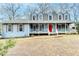 Two-story home with a red front door and a wraparound porch at 3898 Buckland Dr, Lilburn, GA 30047