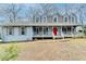 Blue house with white columns and a red front door at 3898 Buckland Dr, Lilburn, GA 30047