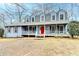 Ranch style home with gray roof, blue siding, and a large front porch at 3898 Buckland Dr, Lilburn, GA 30047