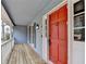Front porch with wooden floors and a red front door at 3898 Buckland Dr, Lilburn, GA 30047