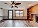 Gathering room with brick fireplace, built-ins, and hardwood floors at 3898 Buckland Dr, Lilburn, GA 30047