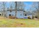 Two-story light blue house with deck and yard at 3898 Buckland Dr, Lilburn, GA 30047