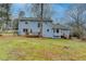 Two-story light blue house with deck and yard at 3898 Buckland Dr, Lilburn, GA 30047