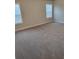 Large bedroom with carpeted floor and two windows at 4513 Eastbrook Pl, Snellville, GA 30039