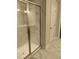 Shower with frameless glass doors and marble tile at 4513 Eastbrook Pl, Snellville, GA 30039