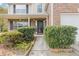 Front entry with black door and well-maintained landscaping at 2015 Winding Crossing Trl, Fairburn, GA 30213