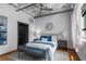 Comfortable bedroom with exposed brick wall and a sitting bench at 878 Peachtree Ne St # 405, Atlanta, GA 30309