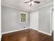 Bedroom with hardwood floors, neutral paint, a ceiling fan, and a closet for ample storage at 3453 Eisenhower E Cir, Atlanta, GA 30354