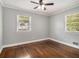 Well-lit bedroom with ceiling fan, hardwood floors and two windows that provide ample natural light at 3453 Eisenhower E Cir, Atlanta, GA 30354