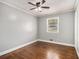 Bedroom with hardwood floors, a ceiling fan, neutral paint, and a window providing natural light at 3453 Eisenhower E Cir, Atlanta, GA 30354