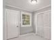 Bedroom featuring neutral paint, a window with blinds, and closet doors at 3453 Eisenhower E Cir, Atlanta, GA 30354