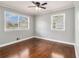 This bedroom has hardwood floors, fresh paint, windows, and a ceiling fan at 3453 Eisenhower E Cir, Atlanta, GA 30354