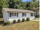 Charming single story home featuring a landscaped front yard with green grass at 3453 Eisenhower E Cir, Atlanta, GA 30354