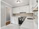 The kitchen has white cabinets, stainless steel appliances and marble countertops at 3453 Eisenhower E Cir, Atlanta, GA 30354