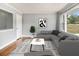 Living room featuring hardwood floors, a large window, neutral paint, and a comfortable sectional sofa at 3453 Eisenhower E Cir, Atlanta, GA 30354