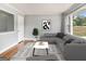 Cozy living room with a large window and gray sectional sofa is perfect for relaxation at 3453 Eisenhower E Cir, Atlanta, GA 30354