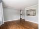 Open living room with gleaming hardwood floors and a pass-through window to the kitchen at 3453 Eisenhower E Cir, Atlanta, GA 30354