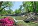 Picturesque pond featuring a cascading waterfall and lush greenery, creating a serene natural setting at 23111 Plantation Ne Dr, Atlanta, GA 30324