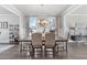 Elegant dining room featuring a modern chandelier, neutral decor, and large windows with soft curtains at 475 Paces Dr, Lithia Springs, GA 30122