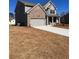 Charming two-story home with a brick and siding exterior, showcasing a spacious driveway and well-maintained lawn at 475 Paces Dr, Lithia Springs, GA 30122