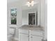 Small bathroom with vanity, toilet, and window at 485 Paces Dr, Lithia Springs, GA 30122