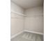 Large walk-in closet with wire shelving and carpet flooring at 495 Paces Dr, Lithia Springs, GA 30122