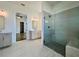Bathroom with glass shower, double sinks, stone floors, and view into main bedroom at 515 Cottage Creek Dr, Cumming, GA 30040