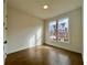Bedroom with hardwood floors and natural light from large window at 515 Cottage Creek Dr, Cumming, GA 30040