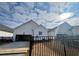 A view of the back of the home, with a fenced yard and open garage at 515 Cottage Creek Dr, Cumming, GA 30040