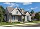 Craftsman style home with gray siding, front porch, and landscaping at 515 Cottage Creek Dr, Cumming, GA 30040