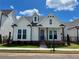 Charming white home featuring a landscaped yard, covered porch, and a combination of modern and traditional architectural elements at 515 Cottage Creek Dr, Cumming, GA 30040